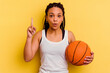 Young african american woman playing basketball isolated on yellow background having some great idea, concept of creativity.