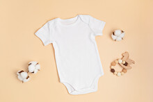 Mockup Of White Infant Bodysuit Made Of Organic Cotton With Eco Friendly Baby Accessories