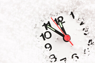 Clock face covered with snow