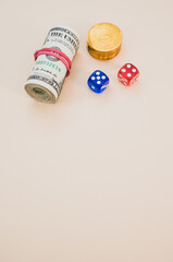 Sticker - Vertical shot of rolled dollars with a red rubber band, gold coins, and dice