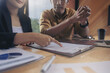 © Panumas - Businesswoman reading documents at meeting, business partner considering contract terms before signing checking legal contract law conditions. Selected focus