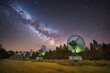 Milky way above astronomical antennas at solar observatory at night