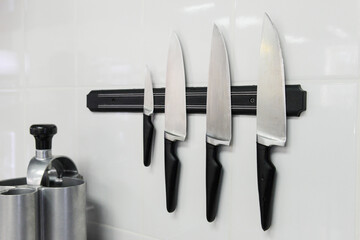 Chef knives with magnetic attachment. Kitchen equipment.