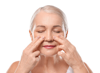 Sticker - Mature woman giving herself face massage on white background