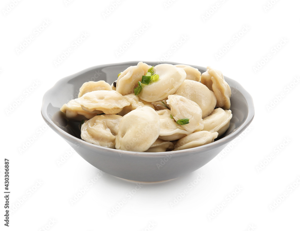 Bowl with tasty dumplings on white background