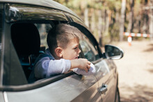 Caucasian Preschool Boy 6-7 Years Old In The Car Looking Through Window. Travel, Vacation Concept.