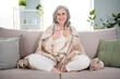 © deagreez - Full length photo of happy positive old woman sit soda warm blanket relax smile indoors inside house home