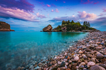 Wall Mural - Low angle view of the soft crystal clear water at shores of Isola Bella in Taormina, Sicily 