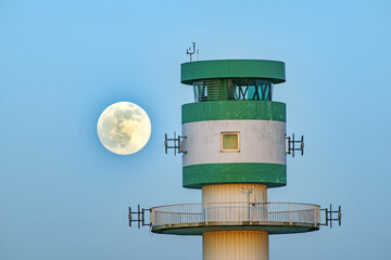 lighthouse on the coast with supermoon