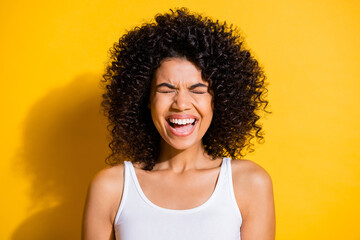 Canvas Print - Photo of funny laughing young dark skin lady wear white singlet closed eyes isolated yellow color background