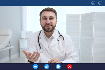 Canvas Print - Pediatrician consulting patient online using video chat in clinic, view from webcam