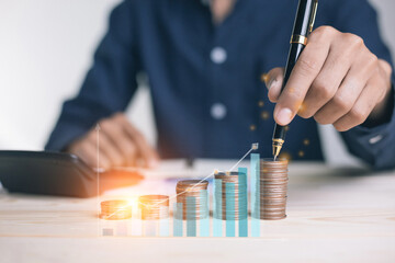 businessman holding coins putting in glass. concept saving money for finance accounting to arrange coins into growing graphs concept.