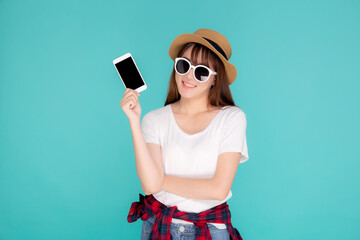 Wall Mural - Beautiful young asian woman showing smart mobile phone for presenting something in travel summer trip in vacation isolated on blue background, asia girl holding smartphone, holiday concept.