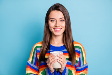 Sticker - Photo of young attractive girl happy positive smile enjoy morning cup of coffee isolated over blue color background