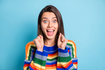 Poster - Portrait of attractive cheerful ecstatic brown-haired girl celebrating attainment isolated over bright blue color background