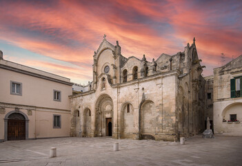 Wall Mural - Matera, Basilicata, Puglia, Italy - The Romanesque Parrocchia di San Giovanni Battista Parish church (chiesa) at sunset. Saint John the Baptist. UNESCO World Heritage Site