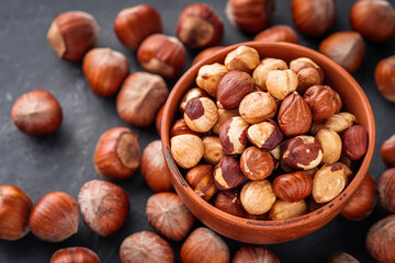 fresh natural hazelnuts on a dark stone background