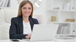 © stockbakers - Appreciative Businesswoman with Laptop Saying Yes by Head Shake