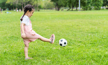 Sports Kid. Happy Little Girl Kid Kicking A Soccer Ball, Child Plays