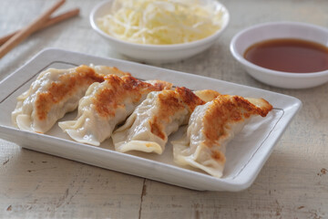 Wall Mural - Fried dumplings Gyoza on plate and soy sauce.