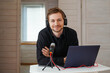© glebcallfives - Portrait of influencer podcast creator streaming audio broadcast at his home. Broadcasting an interview using microphone