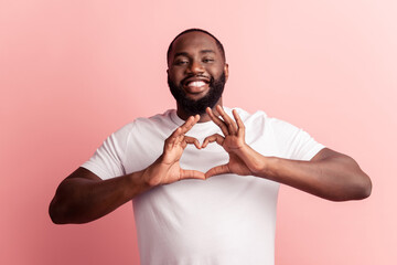 Wall Mural - Portrait of happy lovely man fingers show like heart gesture