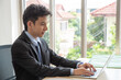 © ic36006 - Smart asian businessman working with laptop at office.