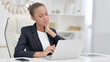 © stockbakers - Tired African Businesswoman with Laptop having Neck Pain in Office