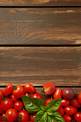 variety of miniature tomatoes on dark wooden surface