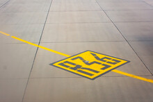 Airport yellow taxiway lines R36 markings on the apron on concrete asphalt, sign for airplane pilots.