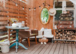 interior of the summer country cozy wooden rustic terrace with vintage accessories furniture. Atmospheric interior room for summer vacation in the country.