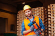 © oksix - Professional woodworker in hardhat holding pneumatic hammer