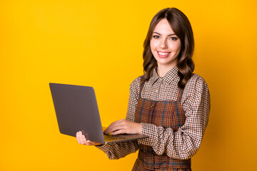 Poster - Photo of optimistic brunette lady with laptop wear brown shirt isolated on vivid yellow color background