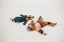 Canada, Ontario, Brother And Sister Doing Snow Angels