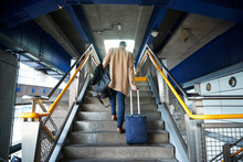 UK, London, Man With Luggage Walking Up Steps