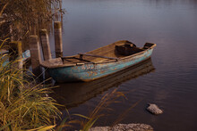 Ukraine, Old Wooden Boat Moored On Lake