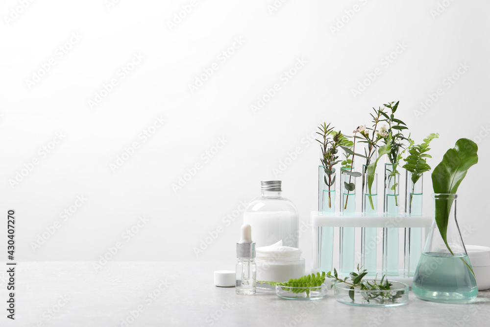 Organic cosmetic product, natural ingredients and laboratory glassware on white table, space for text - obrazy, fototapety, plakaty 