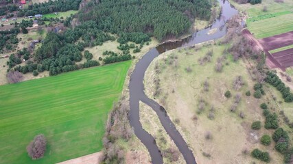 Wall Mural - 4k drone view of Liwiec River among fields near Starowola village in Masovian Voivodeship of Poland