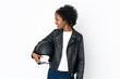 © luismolinero - Young African American woman with a motorcycle helmet isolated on white background looking to the side