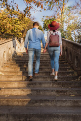 Wall Mural - A beautiful young tourist couple are walking up stairs and looking around the castle of Buda in Budapest in autumn