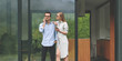 © Epic_pic - Front view of young business couple working on the terrace with smartphones