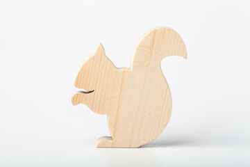 Squirrel figurine carved from solid pine by hand jigsaw. On a white background