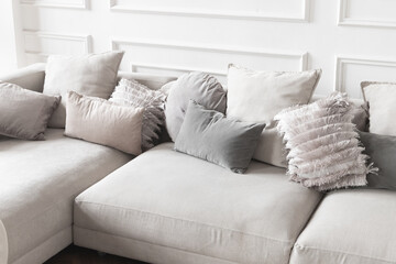 Gray sofa with pillows on it, abstract empty cozy home interior