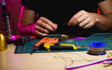 Wall Mural - Artisan holding wires near tools and flex neon in workshop 