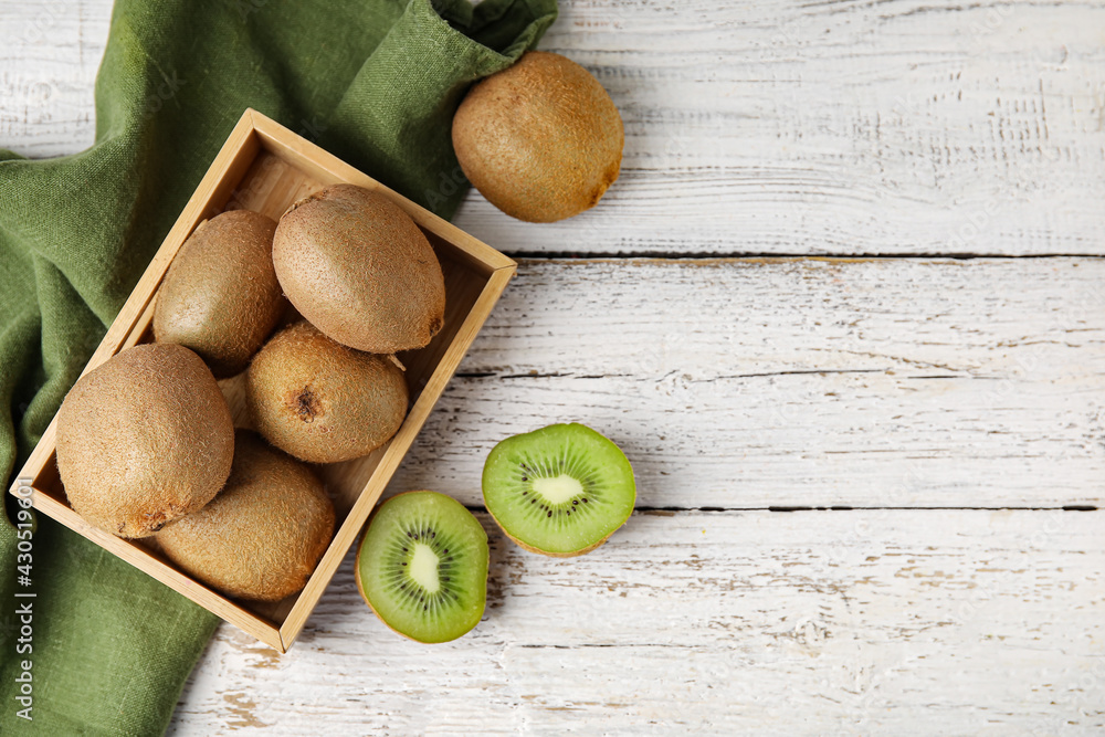 Tasty kiwi on light wooden background