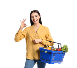 Sticker - Young woman with shopping basket showing OK on white background