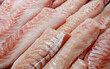 Seabass, hamour, grouper fish, sea bass fillet many pieces sliced piled bulk in fish market.