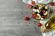 © Atlas - Concept of delicious food with Greek salad on gray textured background