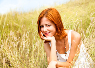 Sticker - Beautiful red-haired girl at grass