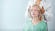 © Dragana Gordic - Professional Reiki healer doing Reiki treatment to young woman in health spa center. Healing and balancing heart and crown chakras. Attractive young woman having reiki treatment